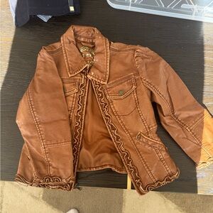 Girls fly leather Jacket with Ruffle Trim. Worn around the collar.